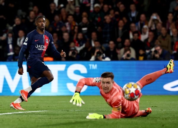 Paris Saint-Germain's French forward #10 Ousmane Dembele (L) watches his shot during the UEFA Champions League quarter final first leg football match between Paris Saint-Germain (PSG) and FC Barcelona at the Parc des Princes stadium in Paris on April 10, 2024. (Photo by Anne-Christine POUJOULAT / AFP) (Photo by ANNE-CHRISTINE POUJOULAT/AFP via Getty Images)